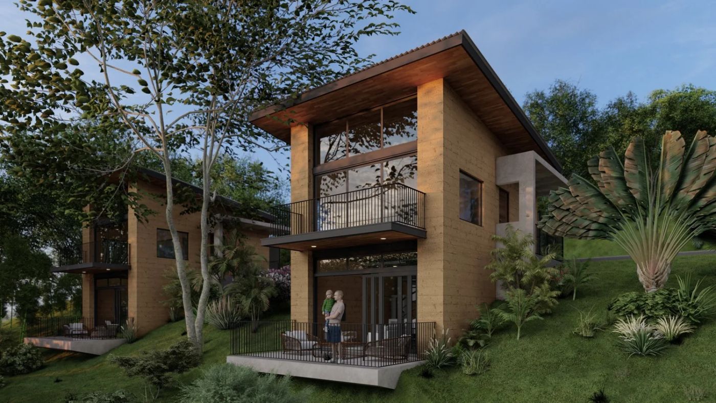 Amazilia two-story home with large glass windows and a balcony